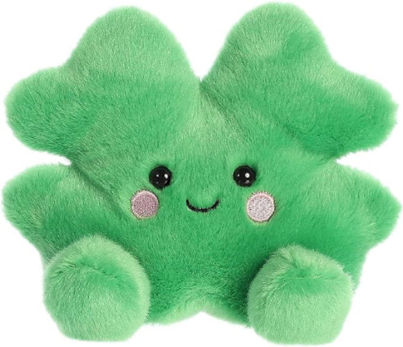 Green plush toy with a smiling face on a white background