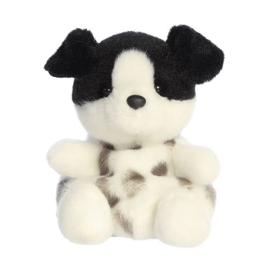 Black and white stuffed dog toy on a white background