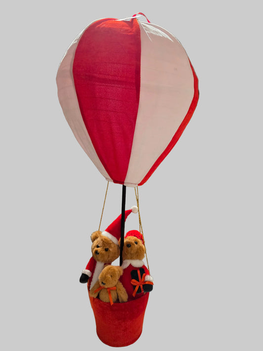 Red hot air balloon with teddy bears in a basket on a gray background