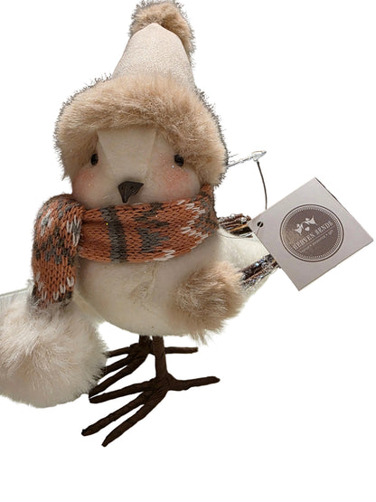 Plush bird toy with a hat and scarf, attached to a tag, on a white background