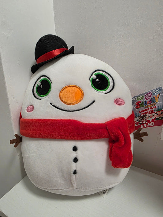 Plush toy resembling a snowman with a red scarf on a white surface.