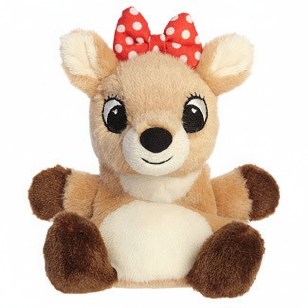 A plush toy deer with light brown fur, a cream-colored belly and inner ears, dark brown paws and feet, and a red bow with white polka dots on its head, set against a plain light gray background.