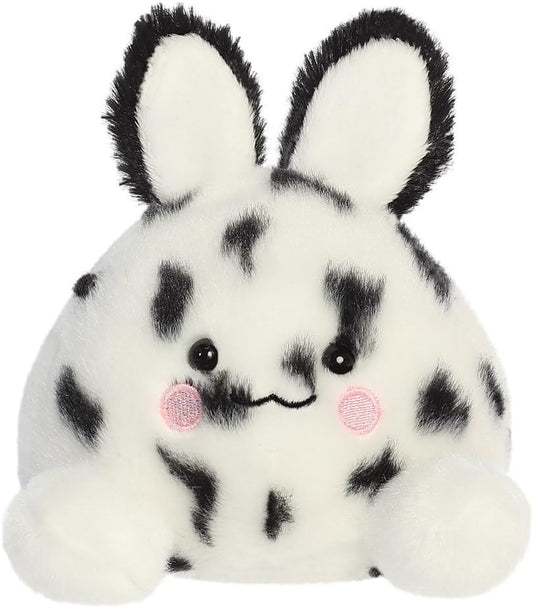 A plush toy resembling a sea bunny with black and white spots and a soft, cuddly texture.