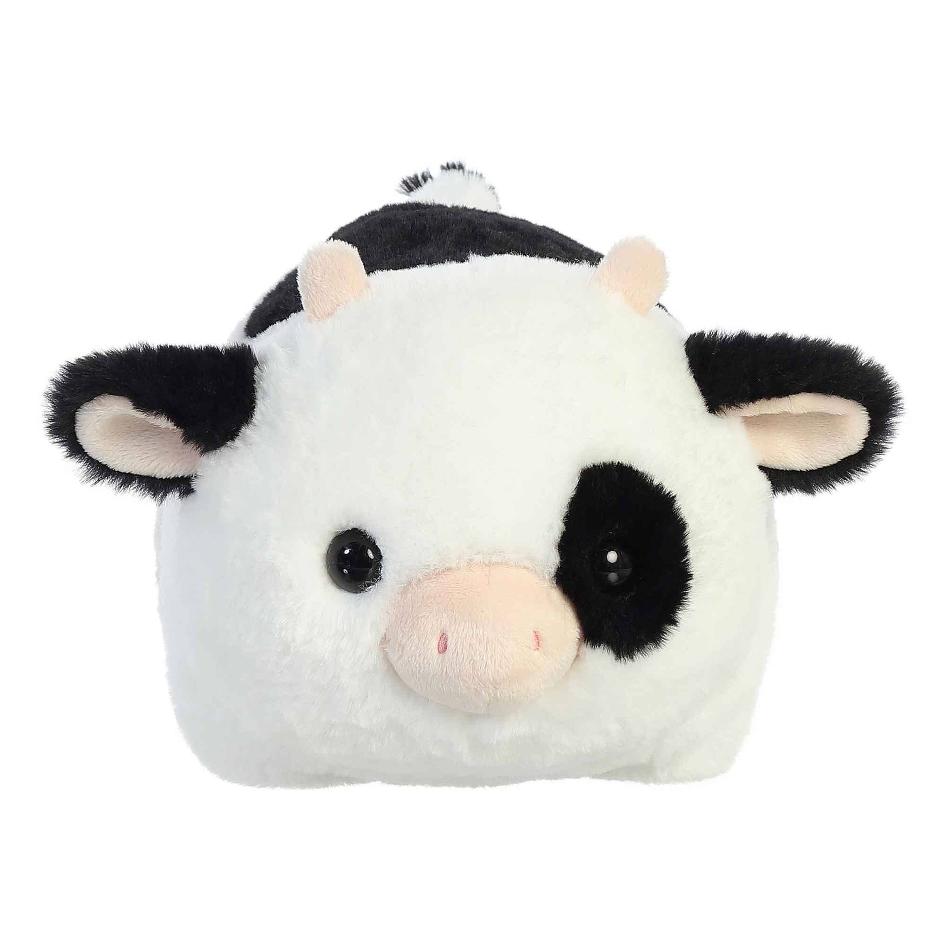 Plush toy cow with black and white pattern on a white background