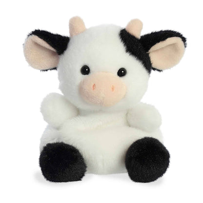 Plush cow toy with black and white pattern on a white background