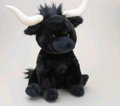 Black plush toy with white horns on a light gray background